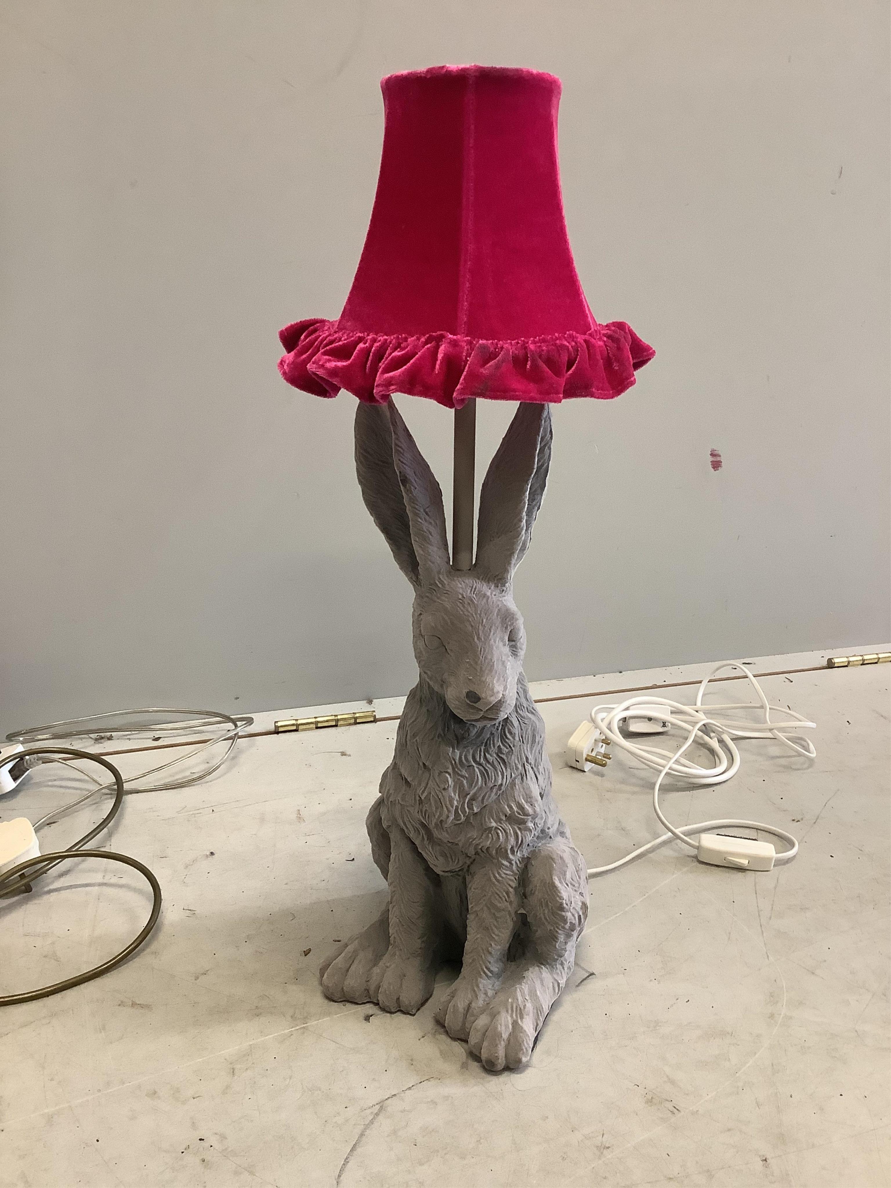 A Contemporary adjustable floor lamp, a table lamp modelled as a hare and two others. Condition - fair to good